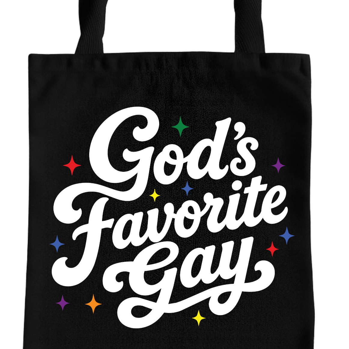 A black canvas tote bag with the phrase 'God's Favorite Gay' printed in large white cursive lettering, accented with small multicolored stars, on a plain white background.