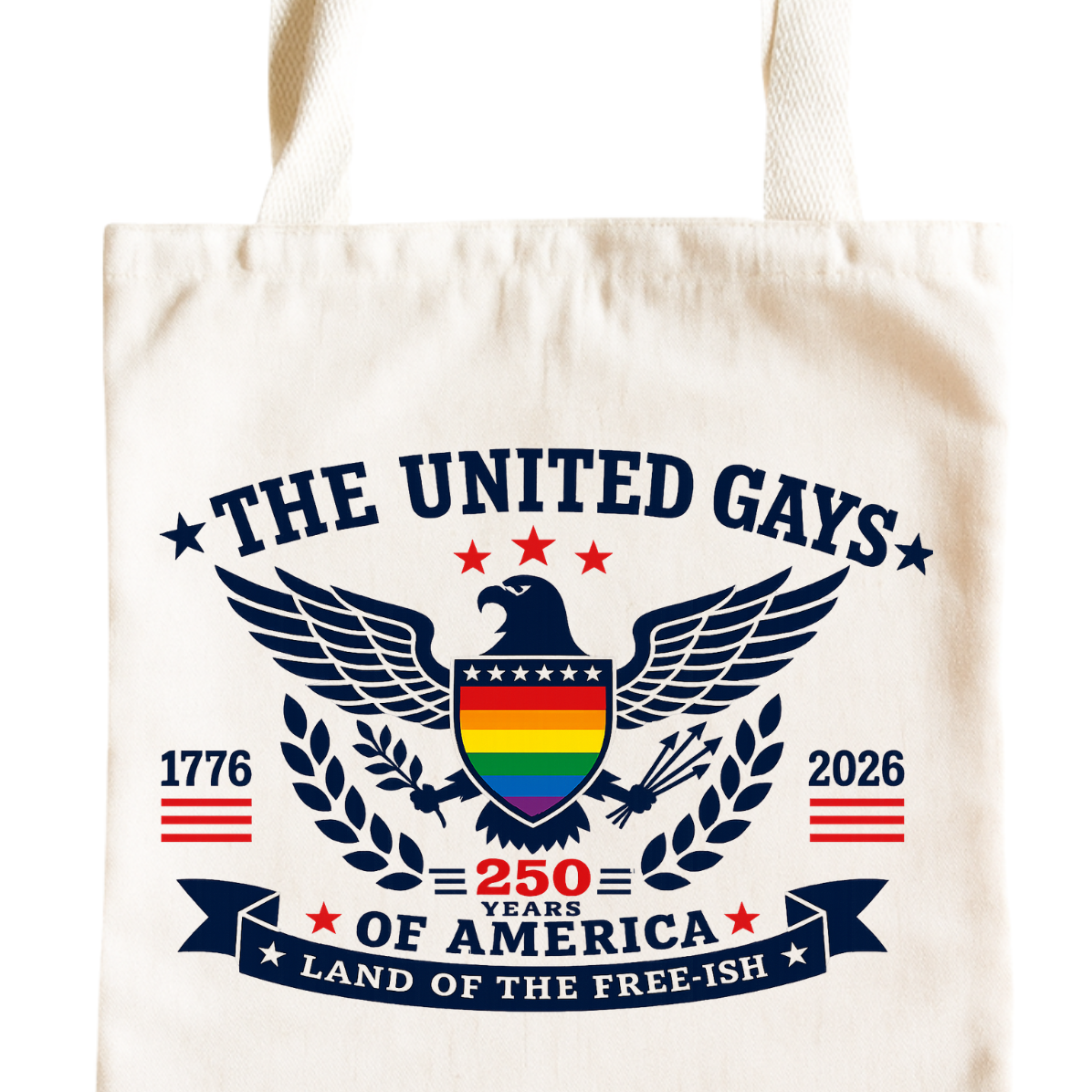 A cream-colored canvas tote bag featuring a detailed graphic print on the front. The design includes a central bald eagle with a rainbow-striped chest, flanked by a laurel wreath, with the text 'THE UNITED GAYS', '250 YEARS OF AMERICA', 'LAND OF THE FREE-15H', '1776', and '2026'.