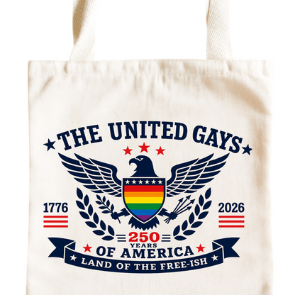 A cream-colored canvas tote bag featuring a detailed graphic print on the front. The design includes a central bald eagle with a rainbow-striped chest, flanked by a laurel wreath, with the text 'THE UNITED GAYS', '250 YEARS OF AMERICA', 'LAND OF THE FREE-15H', '1776', and '2026'.