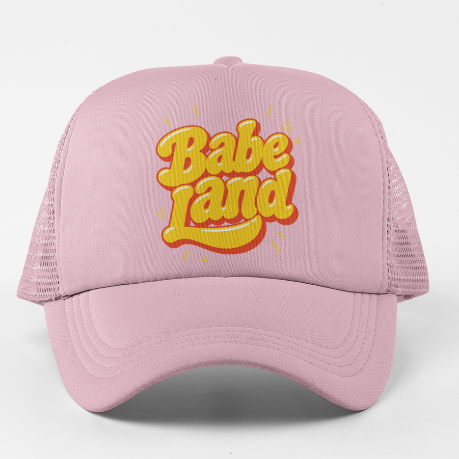 A light pink trucker hat with a yellow and orange 3D-style 'Babe Land' logo on the front, set against a plain white background.