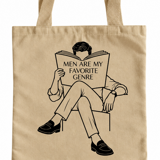 A beige canvas tote bag with a black graphic illustration of a man sitting and reading a book that says 'MEN ARE MY FAVORITE GENRE'.