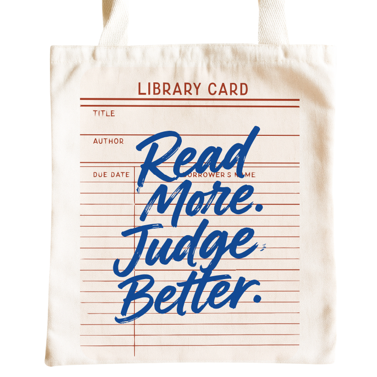 A cream canvas tote bag featuring a library card design with red lines and blue script text that reads 'Read More. Judge Better.